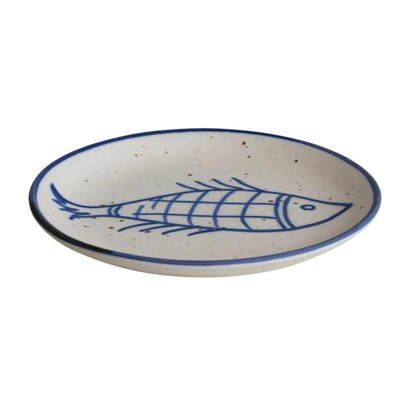 Ceramic plate with blue fish design on a white background