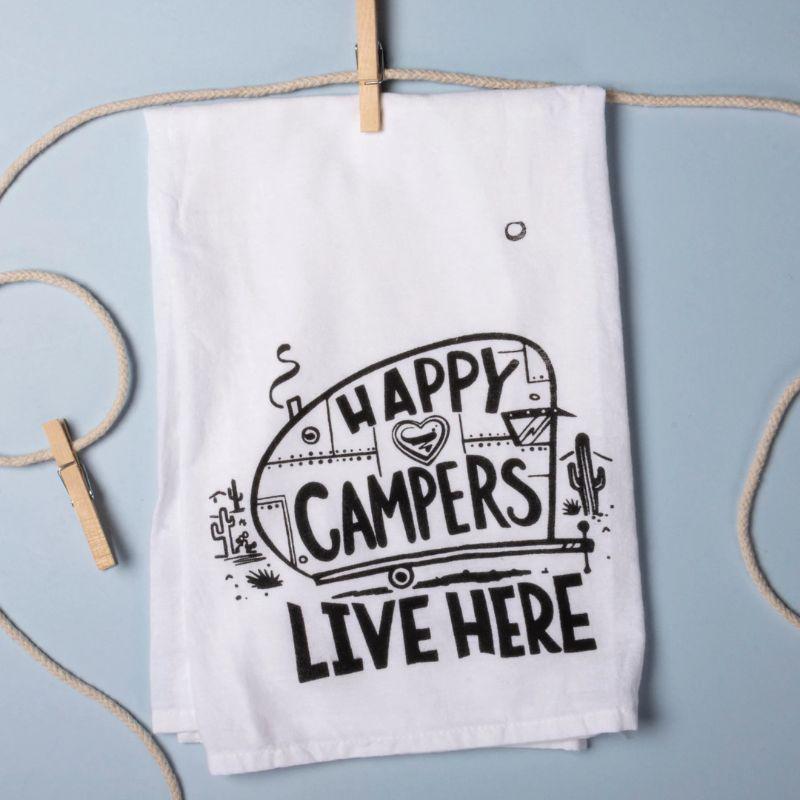 White towel with 'Happy Campers Live Here' text and graphics on a light blue background
