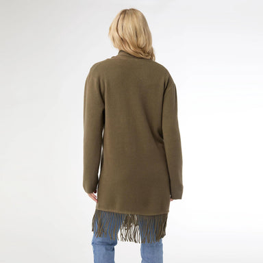 Person wearing a green cardigan with fringe details on a white background