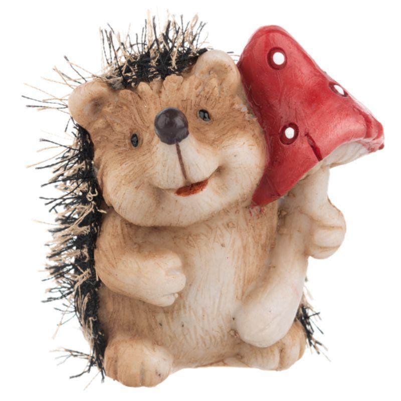 Hedgehog figurine with a red mushroom on a white background