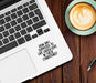 Laptop with a motivational quote on a wooden table next to a cup of coffee.
