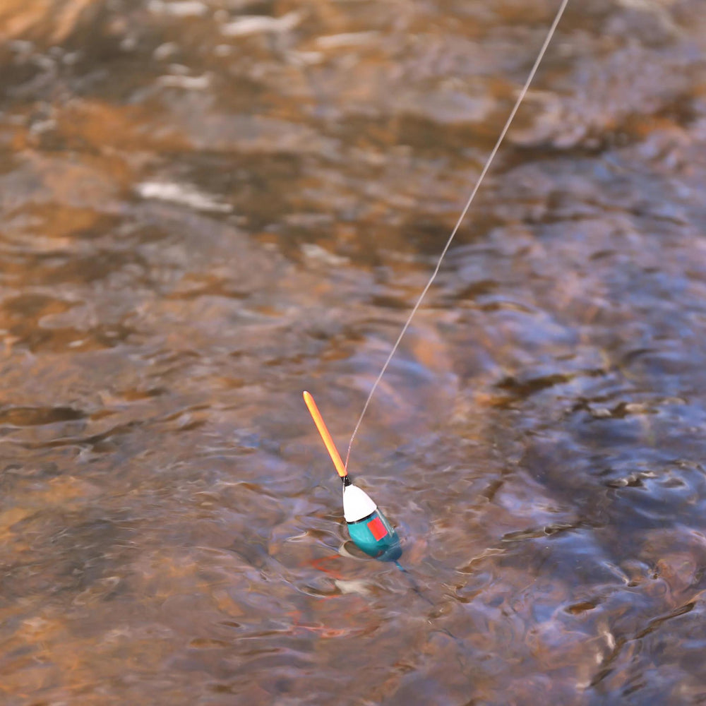 Fishing float with a line floating on water