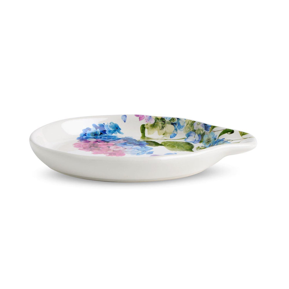 Floral-patterned ceramic spoon rest on a white background