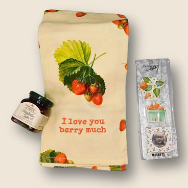 Tea towel with strawberry design and 'I love you berry much' text, jar of jam, and magnet set on a light background