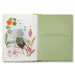 Open book with illustrations of a cat, flowers, and text on a white background