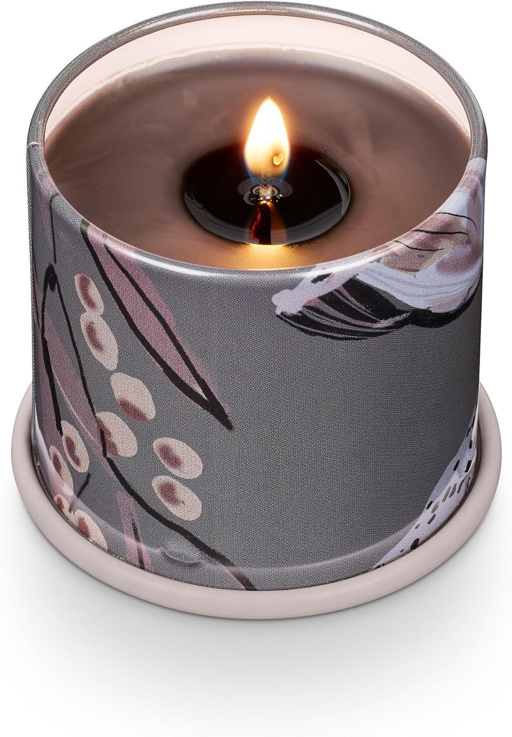 Candle in a decorative container with floral pattern on a white background