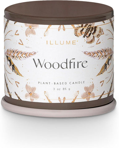 Candle with 'Woodfire' label and butterfly design on a white background