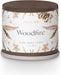 Candle with 'Woodfire' label and butterfly design on a white background