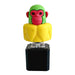 Toy figure of a monkey with a yellow torso and green head on a white background