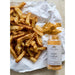 Fries with a jar of 'Italian Stallion' seasoning on white paper