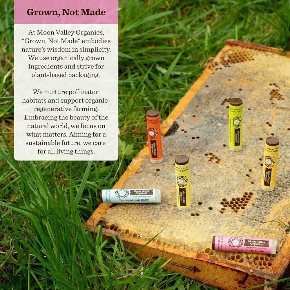 Lip balm tubes on a honeycomb with grass in the background, featuring Moon Valley Organics branding.