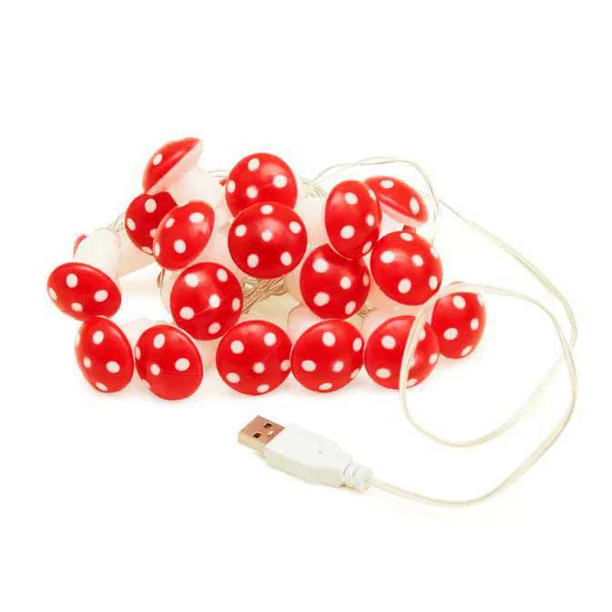 String of red mushroom-shaped lights with white polka dots on a white background