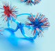 Glasses with red and blue decorative pom-poms on a light blue background
