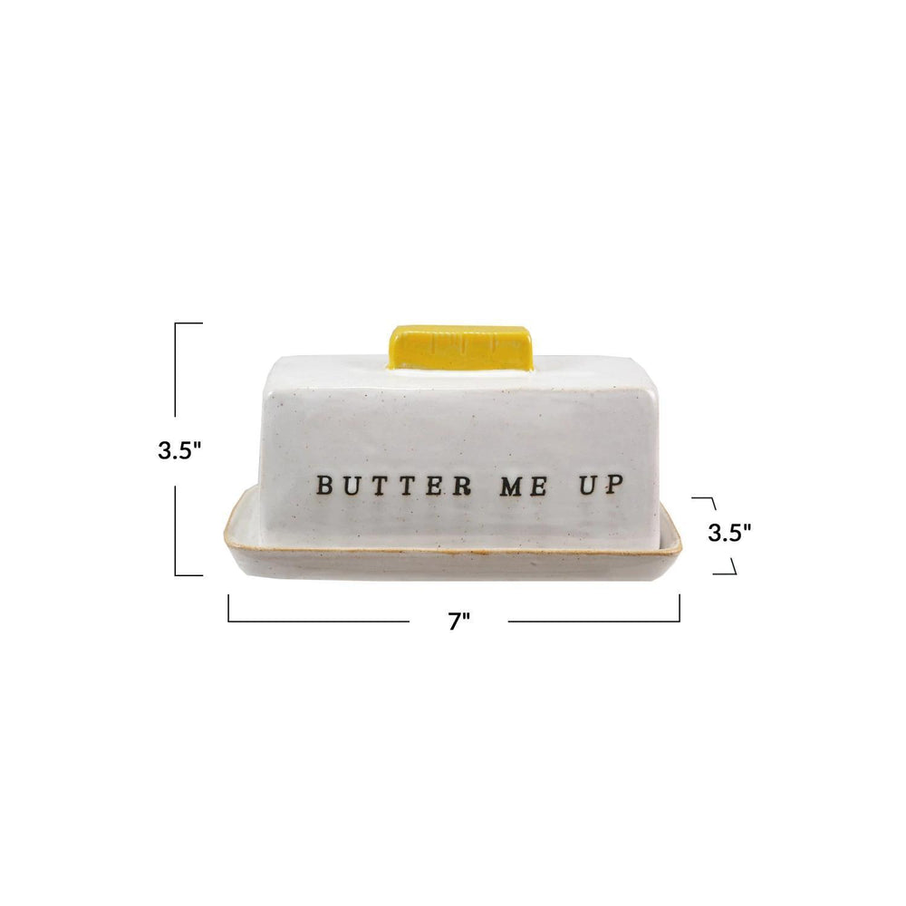 Butter dish with 'BUTTER ME UP' text and yellow lid on a white background