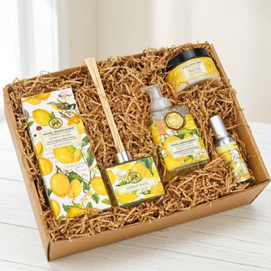 Gift set with lemon-themed products in a decorative box on a light wooden surface.