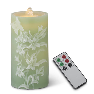 Floral-patterned candle with remote control on a white background