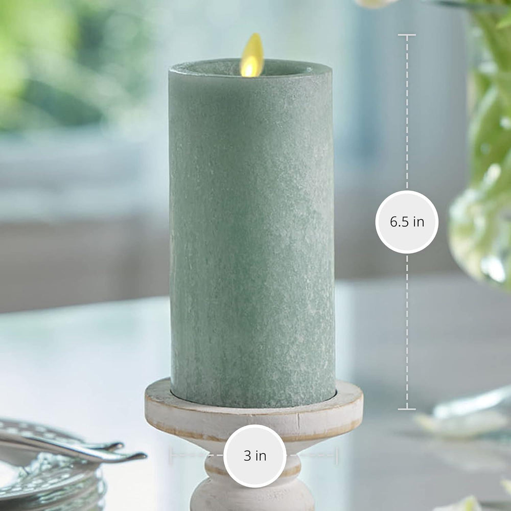 Green candle on a white surface with measurements indicated