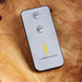 Luminara remote control on a wooden surface
