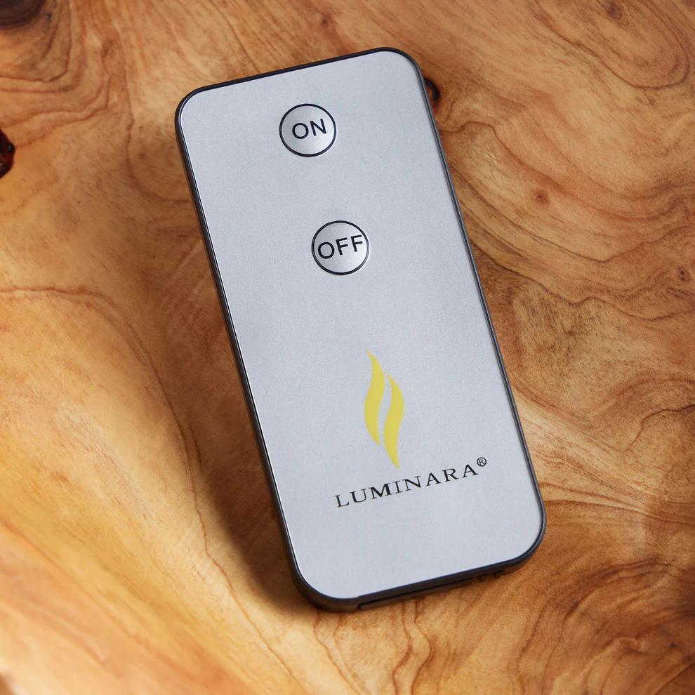Luminara remote control on a wooden surface