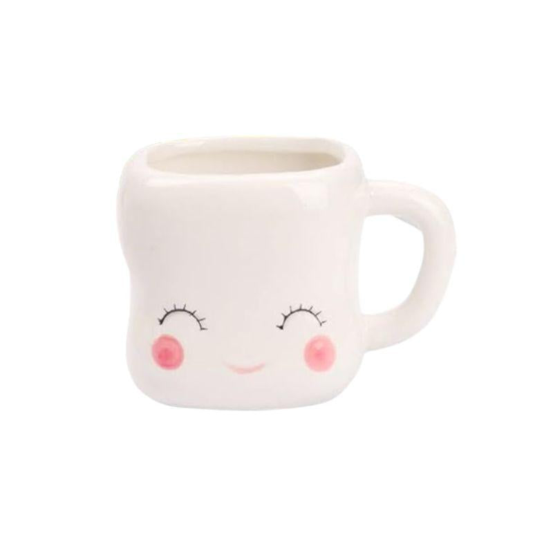 White mug with a face design on a white background