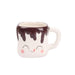 Ceramic mug with a face design and chocolate drizzle on a white background