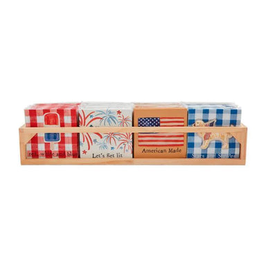 Set of napkins with American-themed designs in a wooden holder on a white background