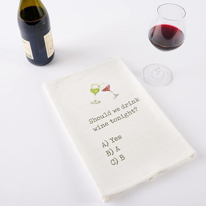 Wine-themed kitchen towel with humorous question and drink icons on a white surface with wine bottle and glass.