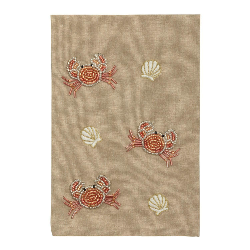 Beige fabric with embroidered crabs and shells on a white background