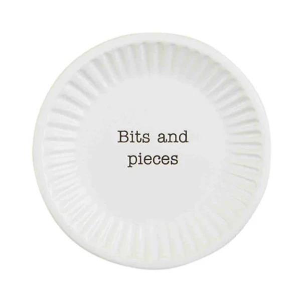 White decorative plate with 'Bits and pieces' text on a white background