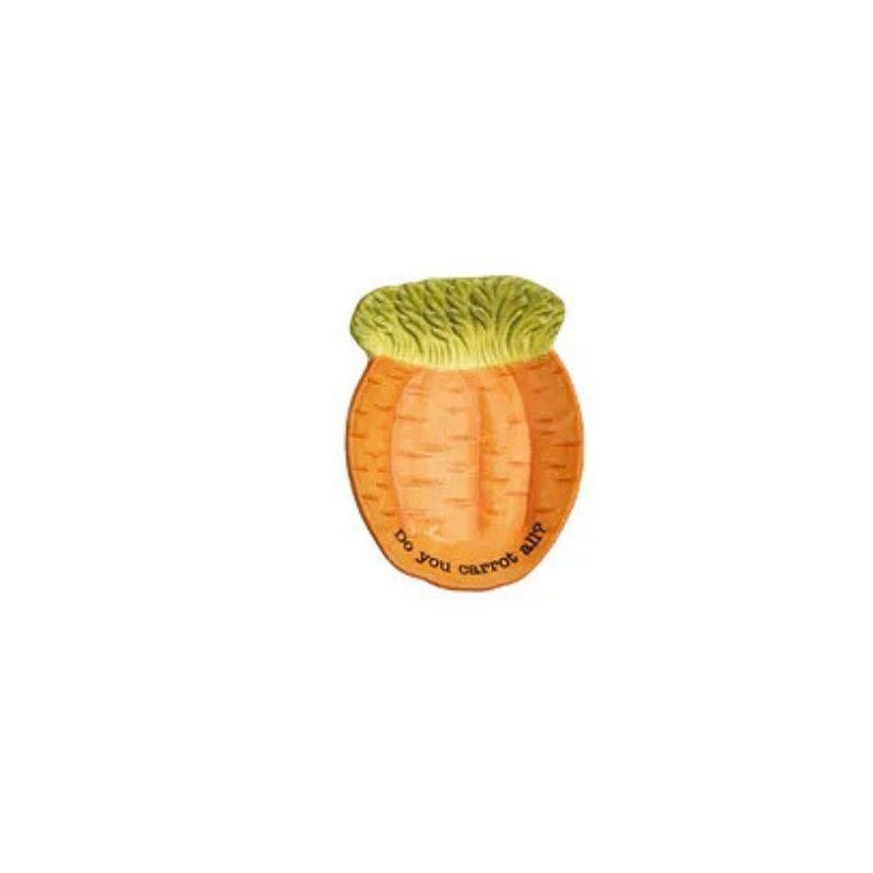 Carrot-shaped Dish with green top on a white background