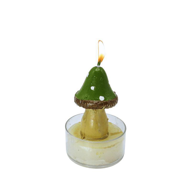 Mushroom-shaped candle with a small flame in a glass holder on a white background