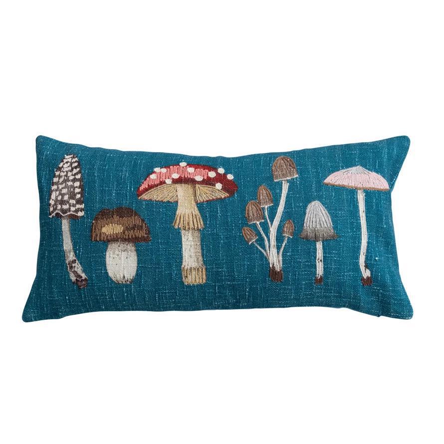 Decorative pillow with embroidered mushrooms on a blue background