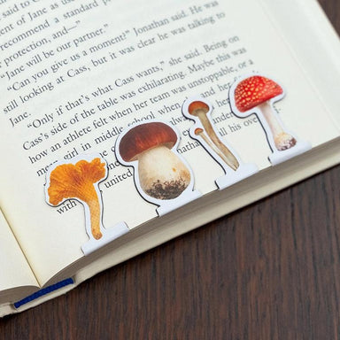 Mushroom-shaped bookmarks on an open book