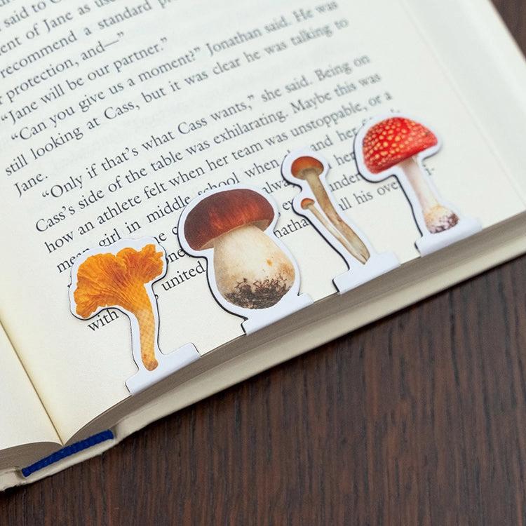 Mushroom-shaped bookmarks on an open book