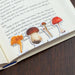 Mushroom-shaped bookmarks on an open book