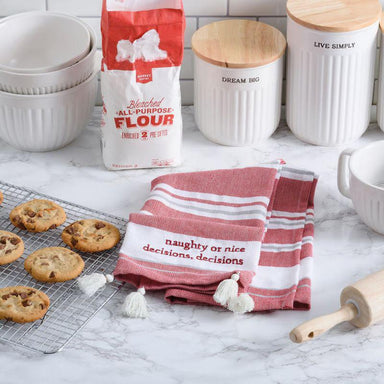 Baking-themed kitchen scene with flour bag, cookies, towel, and rolling pin on a marble countertop.