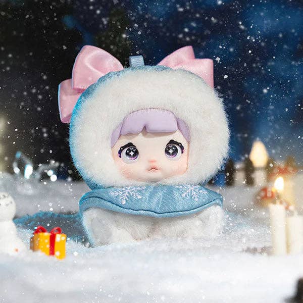 Toy figure in winter clothing with a snowy background