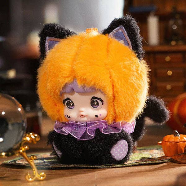 Plush toy with orange fur and black accents on a wooden surface