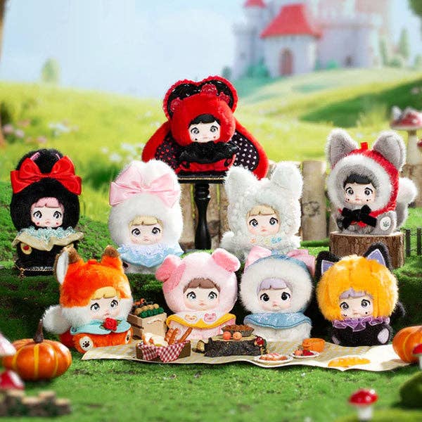 Collection of animated character figurines in various outfits on a grassy field with a castle in the background.