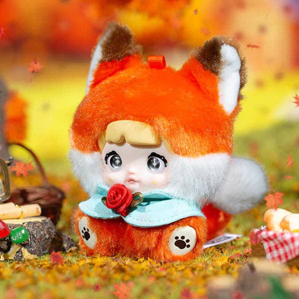 Plush toy with fox-like design in an autumn setting