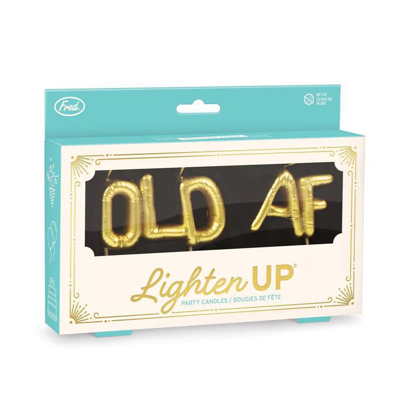 Packaged candles with 'OLD AF' text on a white background