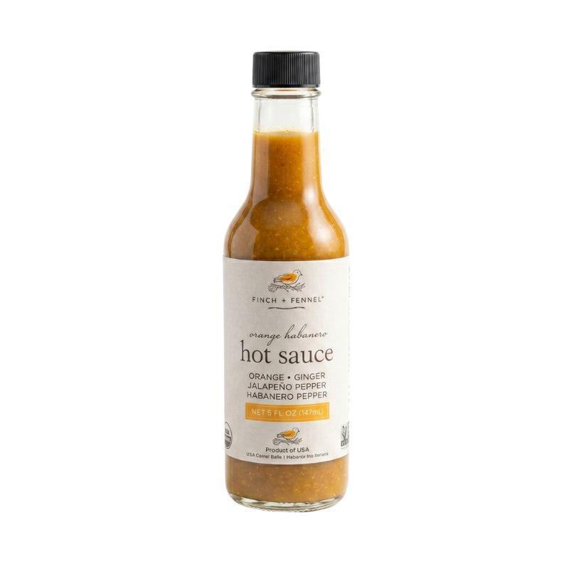 Bottle of hot sauce with a white label on a white background