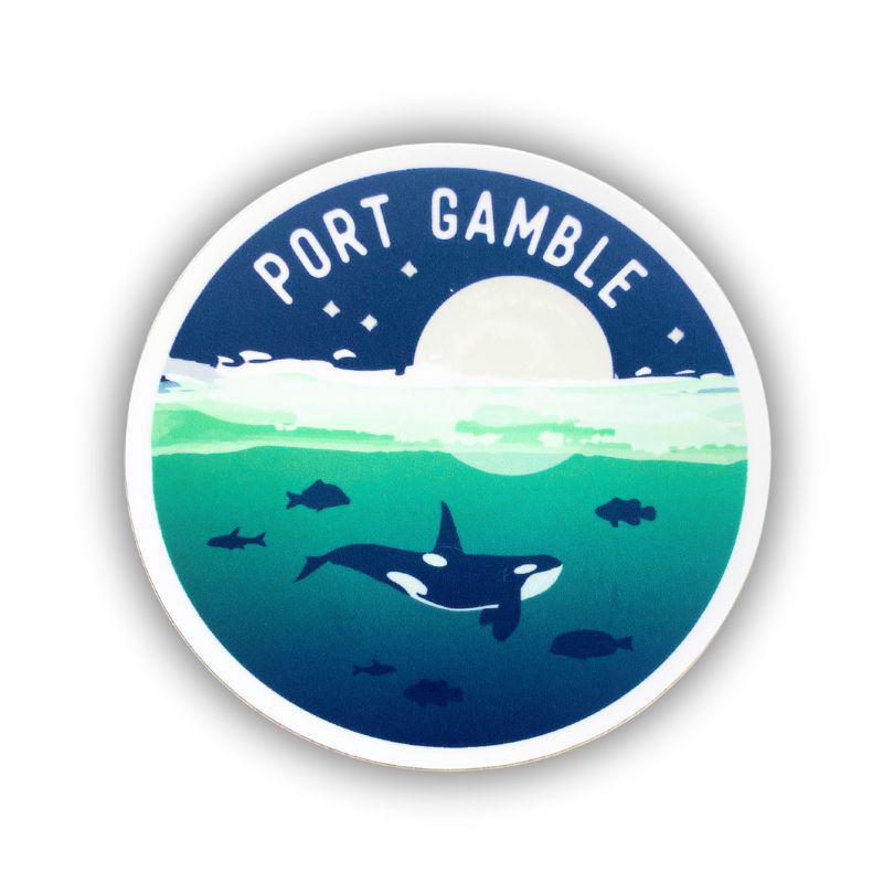 A circular sticker featuring an illustrated underwater scene with an orca, fish, a white moon, and the text 'PORT GAMBLE' at the top, shown on a white background.