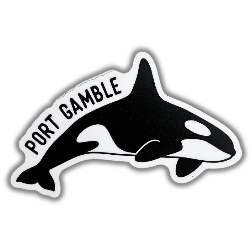 A die-cut sticker featuring a black and white orca illustration with the text 'PORT GAMBLE' in black lettering along the top curve, shown on a plain white background.