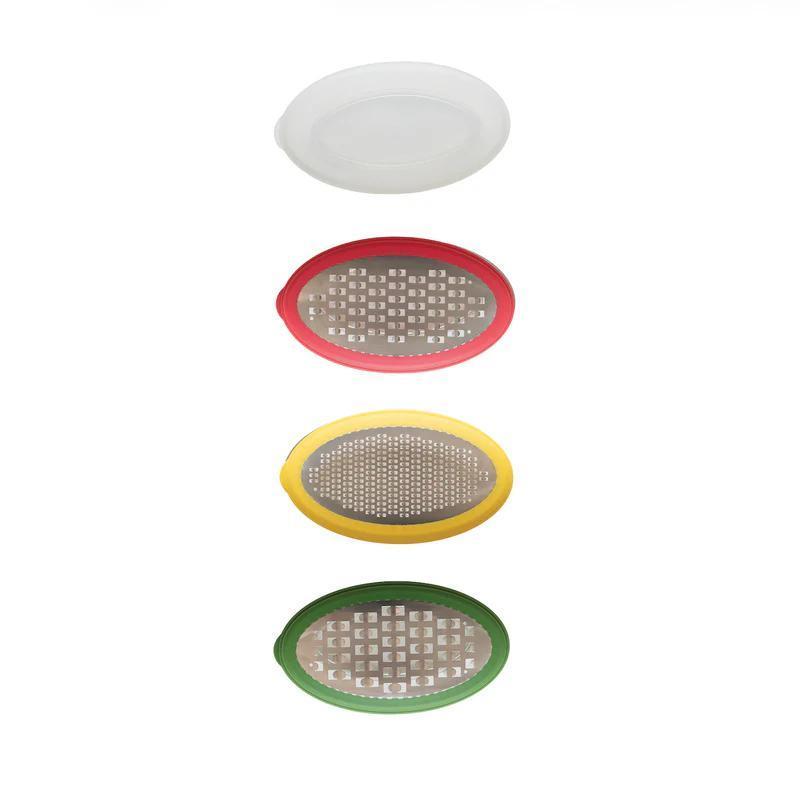 Set of four round grating tools in different colors on a white background