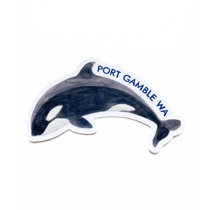 A die-cut sticker featuring a painted gray and black orca dolphin with white markings and the blue text 'PORT GAMBLE WA' along the top, shown on a plain white background.