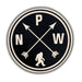 A circular black and off-white sticker or patch featuring the letters N, P, and W arranged around two crossed arrows and a small walking figure silhouette at the bottom, shown on a white background with a soft drop shadow.