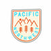 A shield-shaped sticker featuring the words 'PACIFIC NORTHWEST' in light blue, with orange mountain peaks, trees, and a sun on a cream background, shown on a white background.
