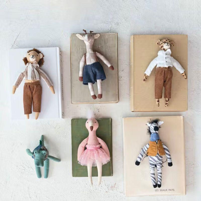 Set of handmade dolls displayed on wooden boards against a light background