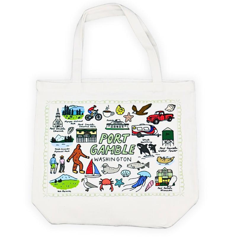 White tote bag with colorful illustrations of Port Gamble, Washington on a white background